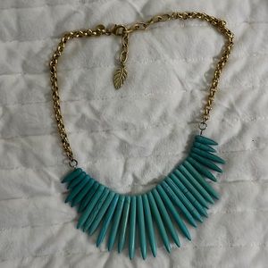 Turquoise necklace with gold color chain and leave detail